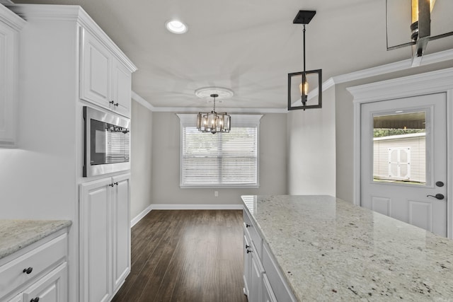 36 Fletcher Dr, Austin, AR 72007 - kitchen featuring built in microwave, a chandelier, crown molding, white cabinets, and dark wood finished floors