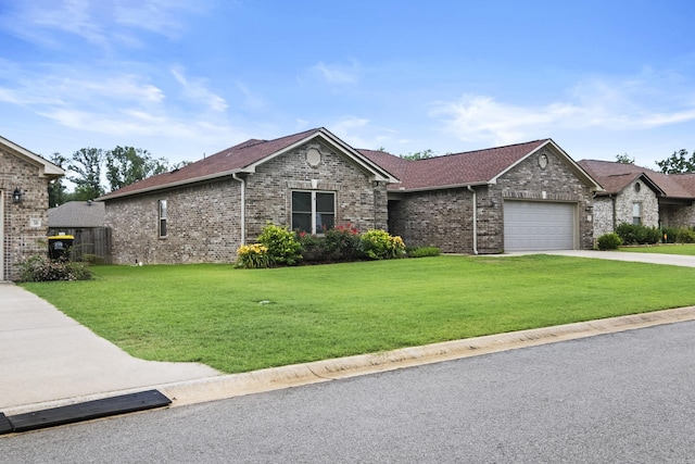36 Fletcher Dr, Austin, AR 72007 - view of front of house with a front yard, an attached garage, driveway, and brick siding