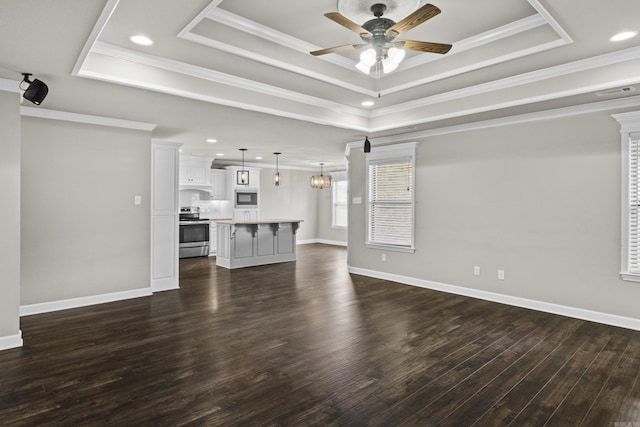 36 Fletcher Dr, Austin, AR 72007 - unfurnished living room with a raised ceiling, ceiling fan, dark wood-style flooring, crown molding, and recessed lighting
