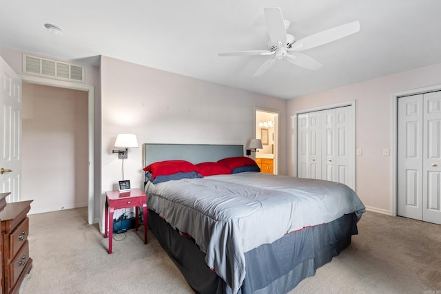 301 Forest Dr, Mountain Home, AR 72653 - bedroom featuring light colored carpet, multiple closets, ensuite bathroom, and a ceiling fan