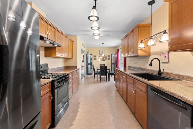 301 Forest Dr, Mountain Home, AR 72653 - kitchen with stainless steel appliances, a ceiling fan, pendant lighting, and brown cabinets