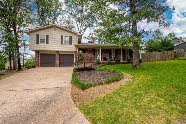 4 Coachlight Cir, Little Rock, AR 72227 - split level home featuring an attached garage, driveway, brick siding, and covered porch