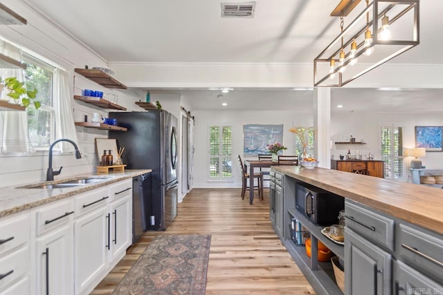 4 Coachlight Cir, Little Rock, AR 72227 - kitchen with open shelves, wood counters, light wood finished floors, and plenty of natural light