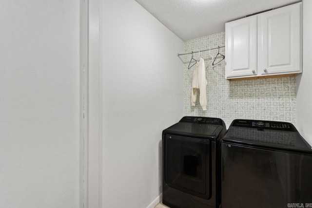 4 Coachlight Cir, Little Rock, AR 72227 - laundry room featuring washing machine and clothes dryer, cabinet space, and a textured ceiling