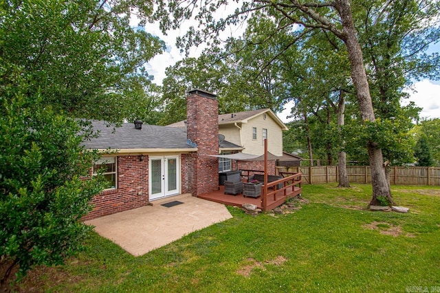 4 Coachlight Cir, Little Rock, AR 72227 - rear view of property with french doors, brick siding, a chimney, a wooden deck, and a patio area