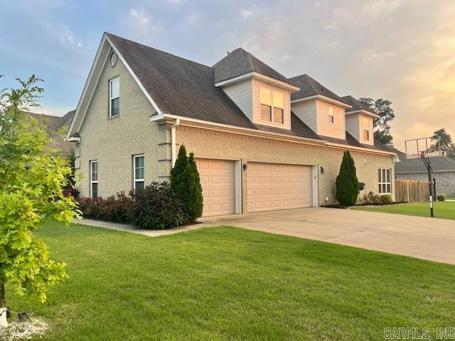 107 Marie Jeanne Dr, Maumelle, AR 72113 - view of front of home featuring a front yard, concrete driveway, an attached garage, and a shingled roof