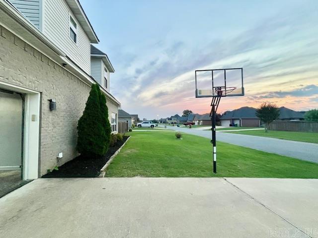 107 Marie Jeanne Dr, Maumelle, AR 72113 - patio terrace at dusk with a yard, a patio area, and a residential view