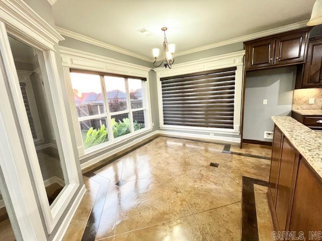 107 Marie Jeanne Dr, Maumelle, AR 72113 - unfurnished dining area featuring a chandelier, ornamental molding, and inlaid floor details