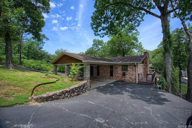 121 Atkinson Ln, Hot Springs, AR 71913 - ranch-style home with driveway, a chimney, a front yard, an attached carport, and brick siding