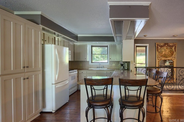 121 Atkinson Ln, Hot Springs, AR 71913 - kitchen featuring white appliances, a peninsula, ornamental molding, dark wood-type flooring, and a breakfast bar area