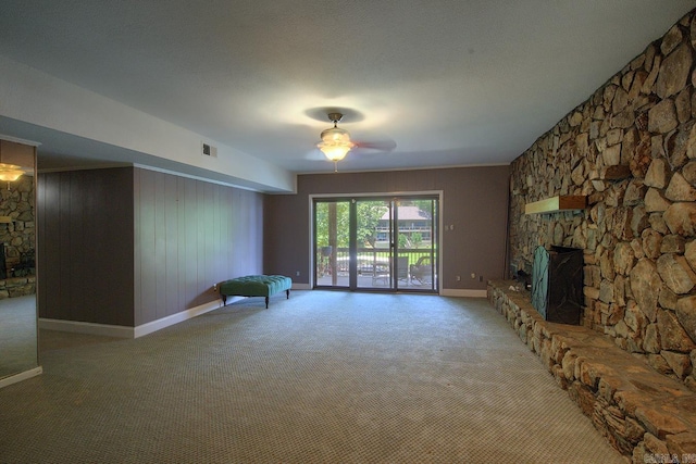 121 Atkinson Ln, Hot Springs, AR 71913 - unfurnished living room featuring a stone fireplace, light colored carpet, and ceiling fan