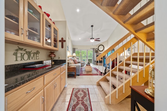 173-B Pebble Beach Pl, Hot Springs, AR 71913 - kitchen with light tile patterned floors, glass insert cabinets, ceiling fan, light brown cabinets, and dark stone countertops