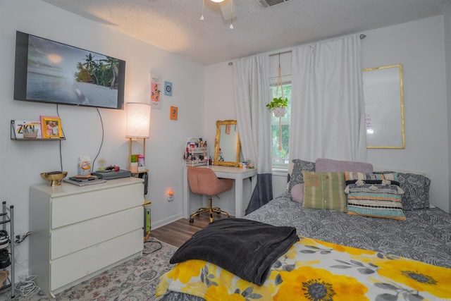 103 N Greer Dr, Searcy, AR 72143 - bedroom featuring wood finished floors, a textured ceiling, and a desk