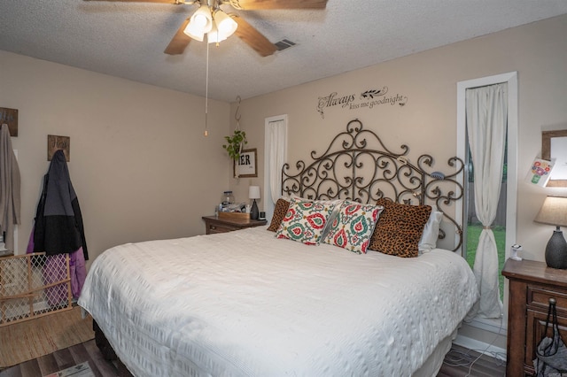 103 N Greer Dr, Searcy, AR 72143 - bedroom featuring a textured ceiling, ceiling fan, and wood finished floors