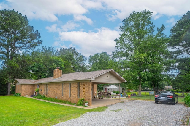 103 N Greer Dr, Searcy, AR 72143 - view of home's exterior with a chimney, brick siding, and gravel driveway