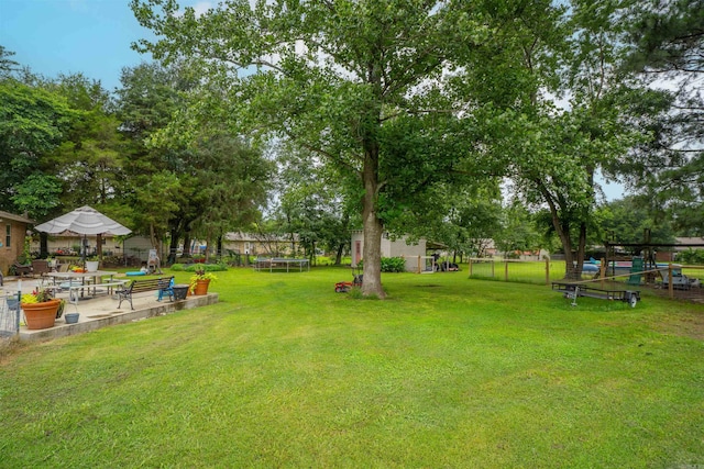 103 N Greer Dr, Searcy, AR 72143 - view of yard featuring a trampoline and a patio area