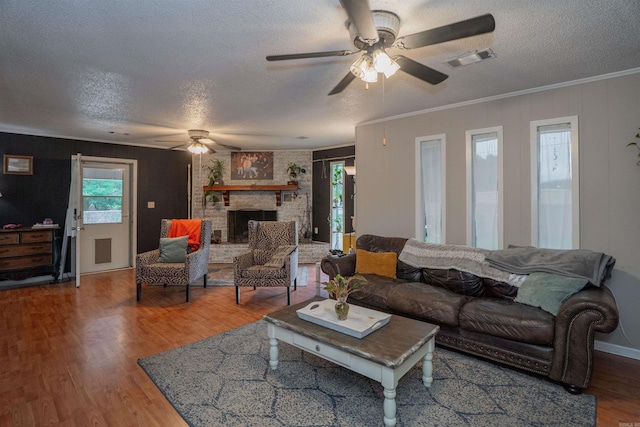 103 N Greer Dr, Searcy, AR 72143 - living room with a ceiling fan, a textured ceiling, wood finished floors, a fireplace, and ornamental molding