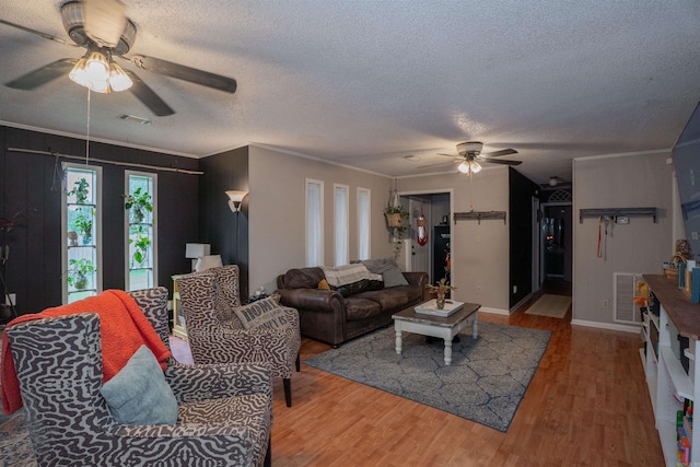 103 N Greer Dr, Searcy, AR 72143 - living area with ceiling fan, wood finished floors, a textured ceiling, and ornamental molding