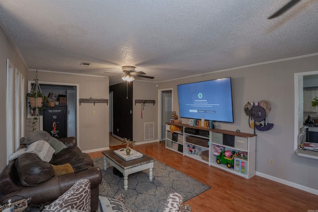 103 N Greer Dr, Searcy, AR 72143 - living room featuring a ceiling fan, wood finished floors, a textured ceiling, and ornamental molding
