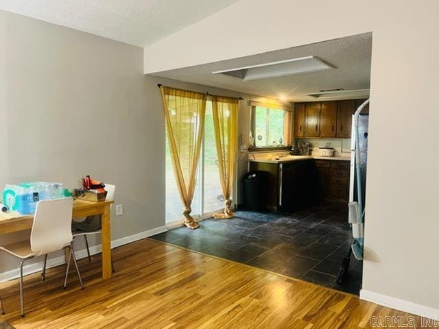 4 Brookway Ln, North Little Rock, AR 72120 - kitchen with light countertops, dark wood-type flooring, dark brown cabinetry, and a textured ceiling