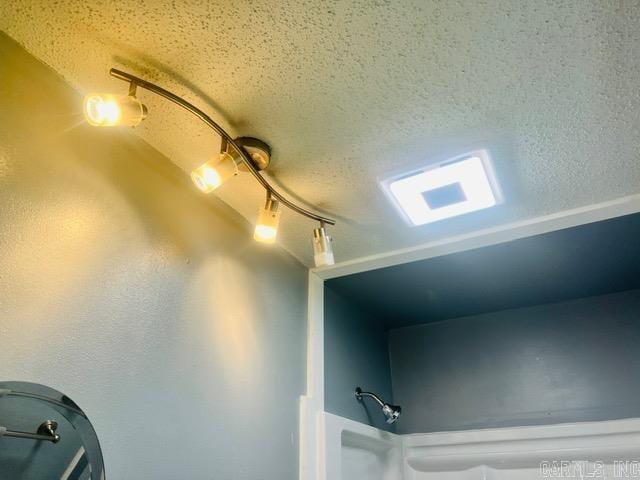 4 Brookway Ln, North Little Rock, AR 72120 - bathroom view of a textured ceiling and track lighting