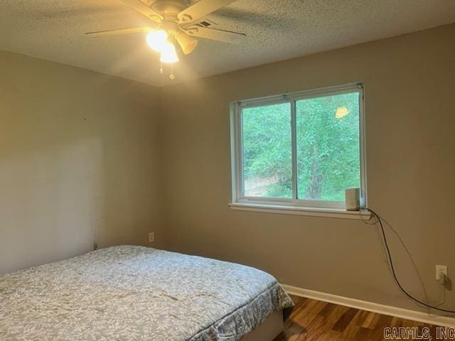 4 Brookway Ln, North Little Rock, AR 72120 - bedroom featuring wood finished floors, a textured ceiling, and ceiling fan