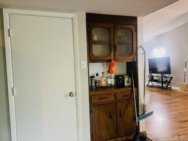 4 Brookway Ln, North Little Rock, AR 72120 - indoor dry bar with light wood finished floors and a textured ceiling