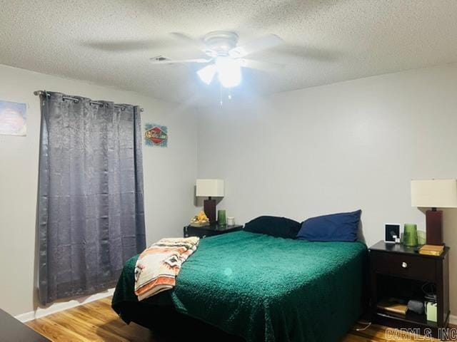 4 Brookway Ln, North Little Rock, AR 72120 - bedroom with wood finished floors, a textured ceiling, and a ceiling fan