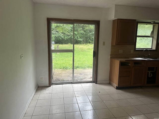 109 Randallwood Dr, Hot Springs Village, AR 71909 - unfurnished dining area featuring healthy amount of natural light and light tile patterned flooring