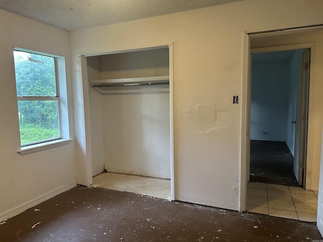 109 Randallwood Dr, Hot Springs Village, AR 71909 - unfurnished bedroom with multiple windows, a closet, and a textured ceiling