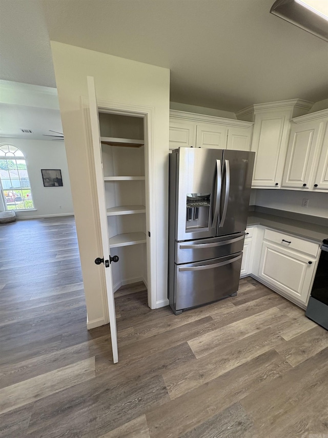 1901 N 19th St, Paragould, AR 72450 - kitchen with stainless steel fridge, dark countertops, white cabinetry, and wood finished floors