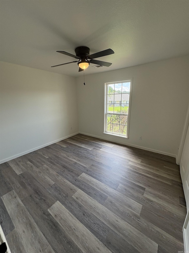 1901 N 19th St, Paragould, AR 72450 - empty room featuring a ceiling fan and dark wood-style flooring