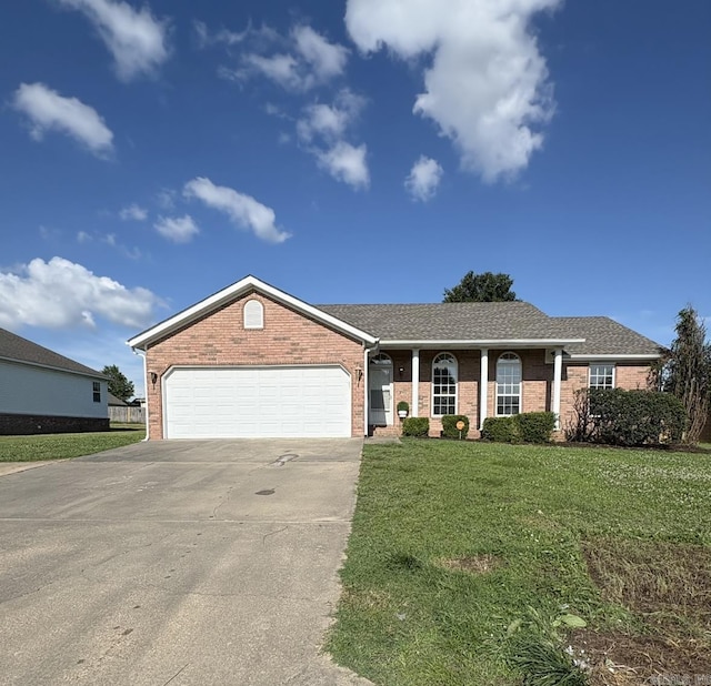 1901 N 19th St, Paragould, AR 72450 - view of front facade featuring brick siding, driveway, an attached garage, and a front lawn