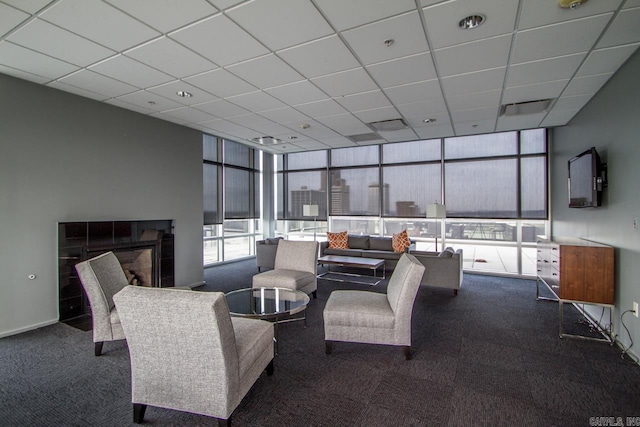 300 E Third St # 509, Little Rock, AR 72201 - living area with carpet flooring, a paneled ceiling, expansive windows, and a tiled fireplace