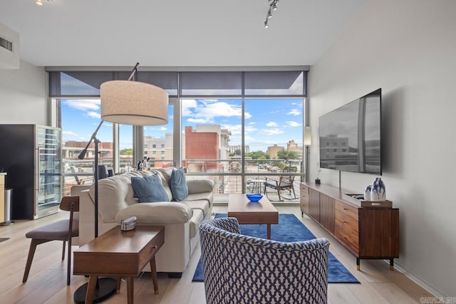 300 E Third St # 509, Little Rock, AR 72201 - living room featuring floor to ceiling windows, light wood-style flooring, and track lighting