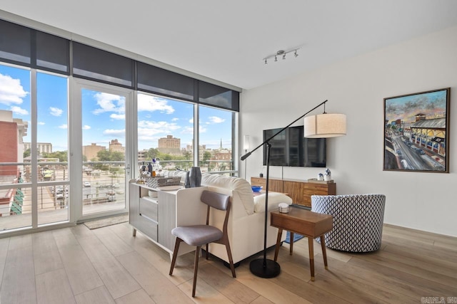 300 E Third St # 509, Little Rock, AR 72201 - living room featuring floor to ceiling windows, wood finished floors, and track lighting