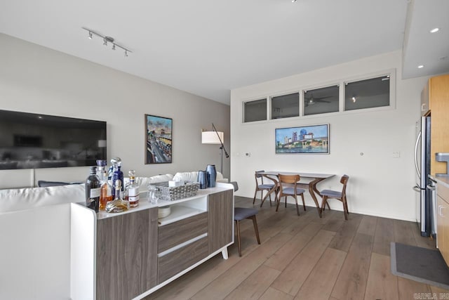 300 E Third St # 509, Little Rock, AR 72201 - living area with wood finished floors, a ceiling fan, and rail lighting