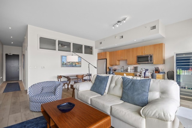 300 E Third St # 509, Little Rock, AR 72201 - living room with light wood finished floors, recessed lighting, and beverage cooler