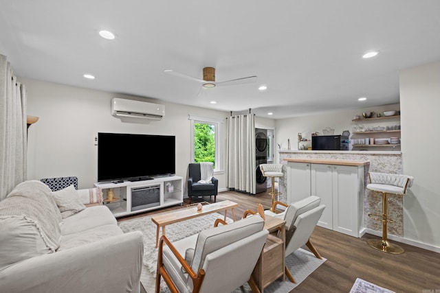117 N Summit St, Little Rock, AR 72205 - living area featuring estacked washer and dryer, a wall unit AC, dark wood-type flooring, a ceiling fan, and recessed lighting