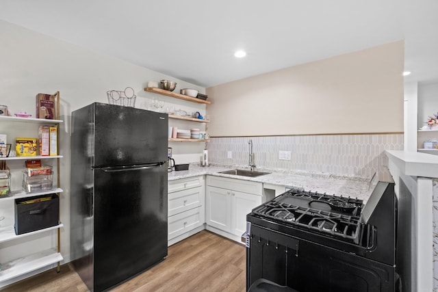 117 N Summit St, Little Rock, AR 72205 - kitchen with black appliances, open shelves, light stone counters, white cabinetry, and light wood finished floors