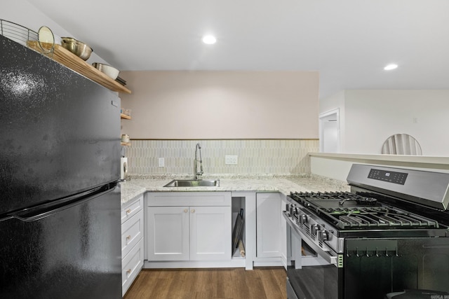117 N Summit St, Little Rock, AR 72205 - kitchen featuring freestanding refrigerator, stainless steel range with gas stovetop, dark wood-style floors, light stone countertops, and recessed lighting