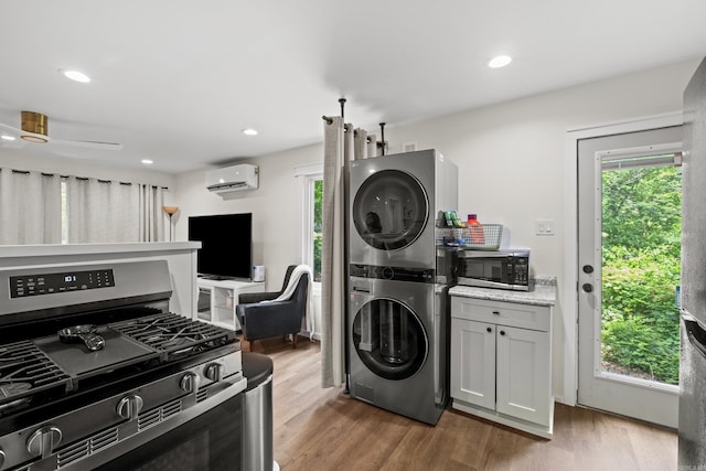 117 N Summit St, Little Rock, AR 72205 - kitchen with stainless steel appliances, stacked washing machine and dryer, a wall mounted AC, healthy amount of natural light, and recessed lighting