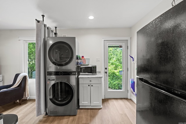 117 N Summit St, Little Rock, AR 72205 - laundry area featuring estacked washer and dryer, light wood-style flooring, healthy amount of natural light, and recessed lighting