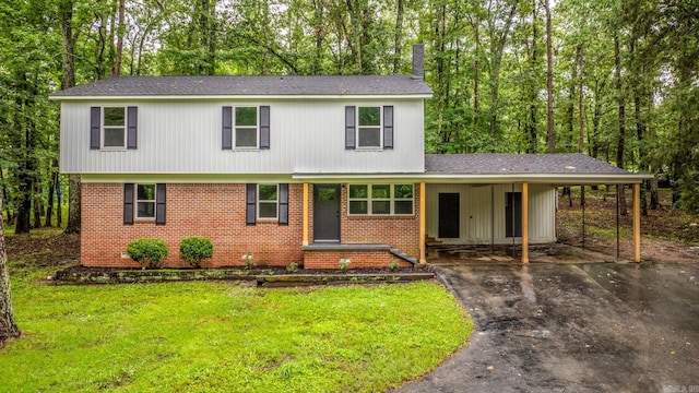 25501 Kanis Rd, Little Rock, AR 72223 - view of front of house featuring asphalt driveway, a front yard, brick siding, and an attached carport