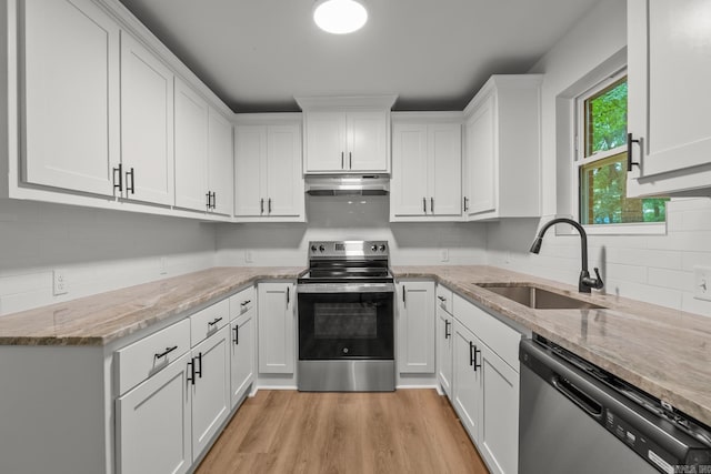 25501 Kanis Rd, Little Rock, AR 72223 - kitchen with stainless steel appliances, under cabinet range hood, white cabinets, backsplash, and light stone counters