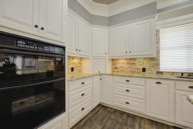 kitchen featuring dark wood-style floors, white cabinets, light stone counters, tasteful backsplash, and crown molding