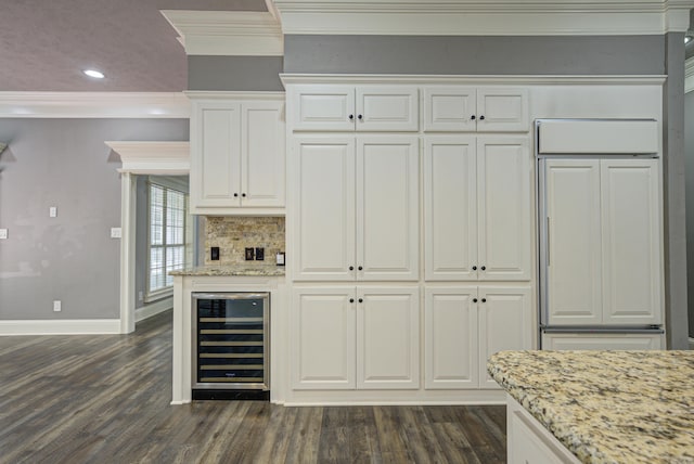 bar featuring wine cooler, crown molding, paneled fridge, dark wood finished floors, and recessed lighting