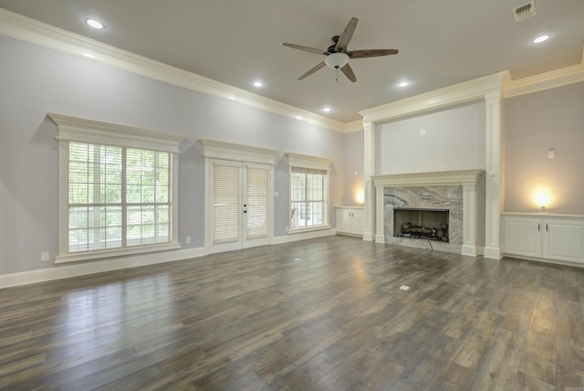 unfurnished living room featuring a ceiling fan, crown molding, wood finished floors, a high end fireplace, and recessed lighting