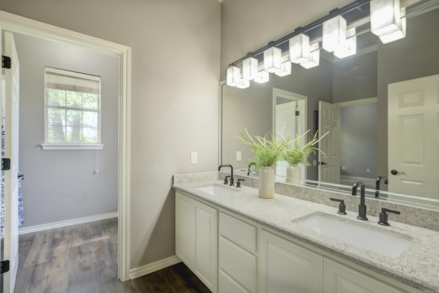 full bathroom with double vanity and wood finished floors