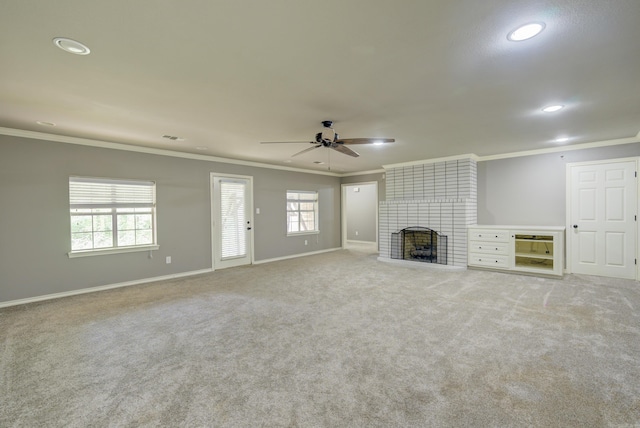 unfurnished living room with ornamental molding, a ceiling fan, recessed lighting, carpet, and a fireplace